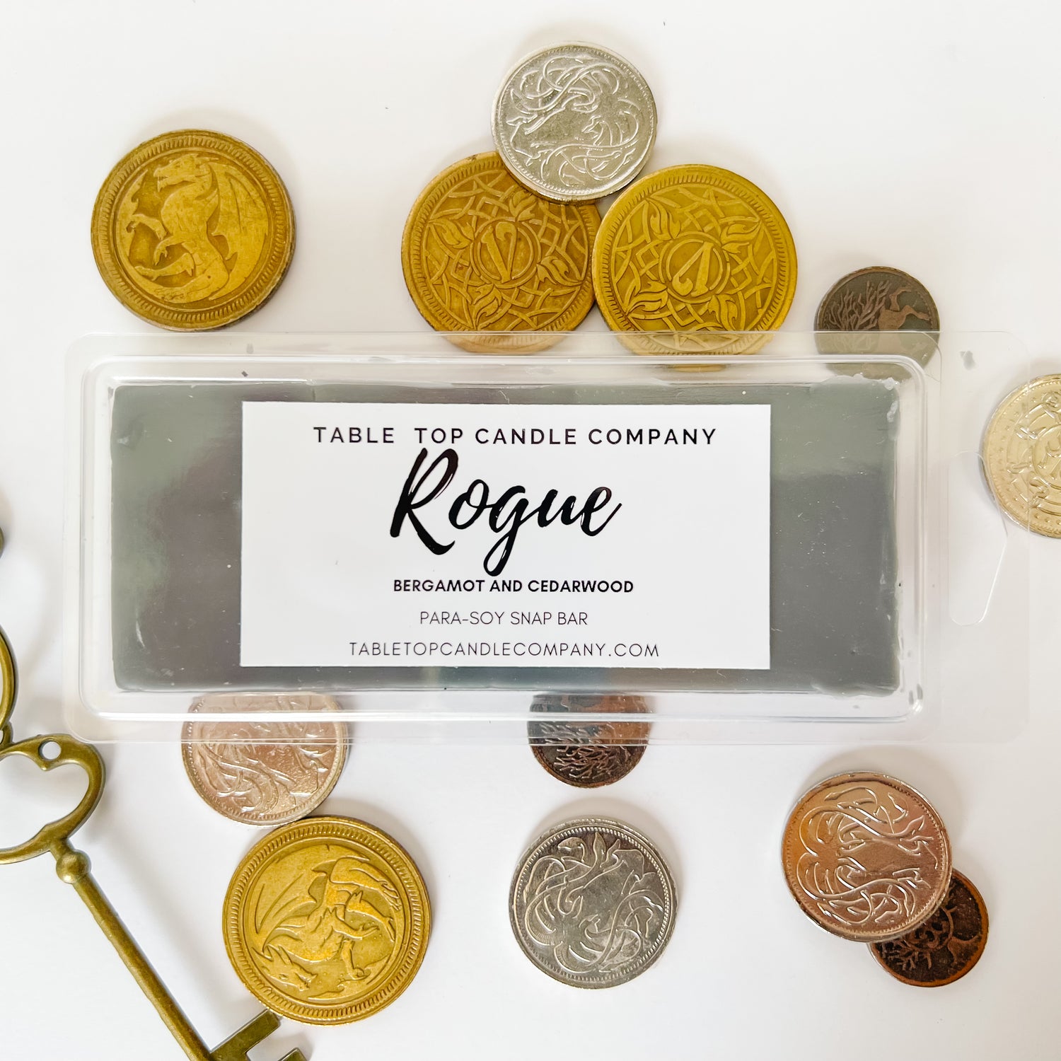 Our Rogue snap bar. It shows the wax snap bar with coins around the packaging. Snap Bars are great for those who want to use wax melters
